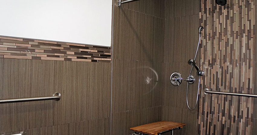 Showing an accessible shower with grab bars.